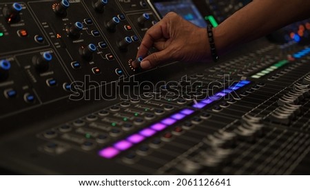 Male finger on audio mixer knob. Focus selected on the knob Royalty-Free Stock Photo #2061126641