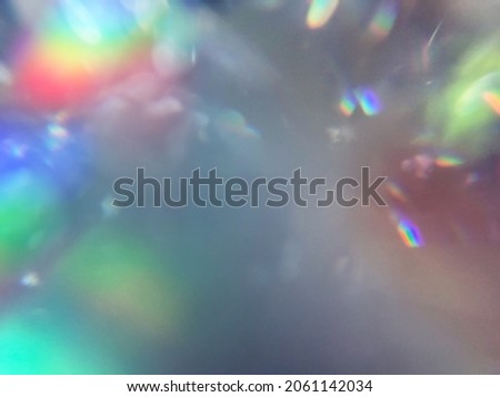 Soft rainbow light flares and glitters background or overlay Royalty-Free Stock Photo #2061142034
