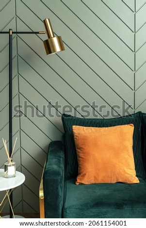 Orange  cushion on a sofa retro interior design Royalty-Free Stock Photo #2061154001
