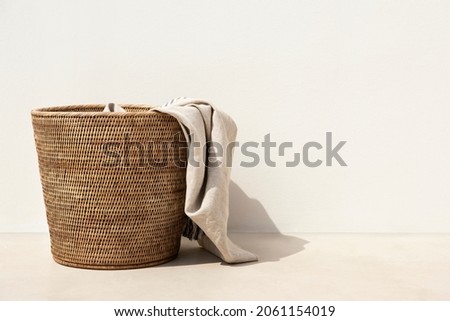 Weaved laundry basket laundry essential in minimal style Royalty-Free Stock Photo #2061154019