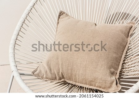 Beige printed cushion on a chair minimal interior design Royalty-Free Stock Photo #2061154025