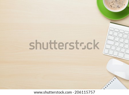 Office table with notepad, computer and coffee cup. View from above with copy space