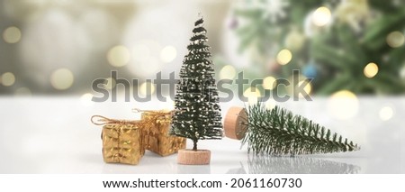Decorated Christmas tree hanging on pine branches gift boxes  and ornaments