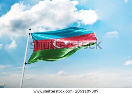 Azerbaycan bayrağı ve mavi gökyüzü bulutlar. Translation: Azerbaijan flag and blue sky with clouds.
 Royalty-Free Stock Photo #2061189389