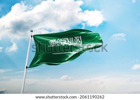 Saudi Arabia flag in the blue sky. 