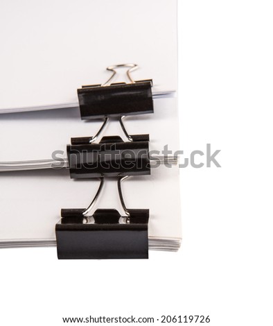 Binder clips with black white paper over white background