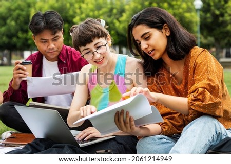 Students studying together outdoors at the campus
