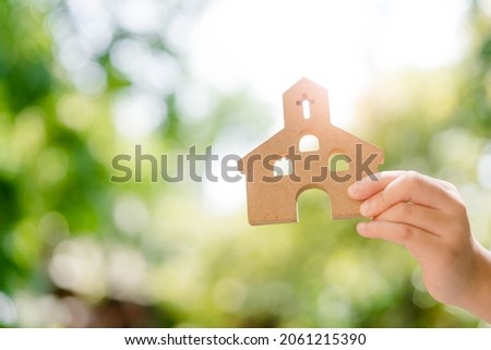 kid hand holding Church with cross for sunday school service.kid church good friday and easter day in church christian catholic.Sunday service.Online worship.Faith Jesus.pray.bible study.good gospel. Royalty-Free Stock Photo #2061215390