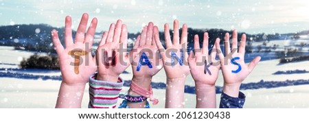 Children Hands Building Colorful Word Thanks. Snowy Winter Background With Snowflakes