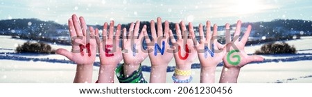Children Hands Building Colorful German Word Meinung Means Opinion. Snowy Winter Background With Snowflakes