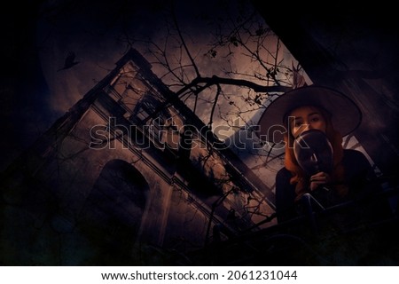 Halloween witch holding black face mask standing over grunge castle, dead tree, bird fly, full moon and spooky cloudy sky, Halloween mystery concept