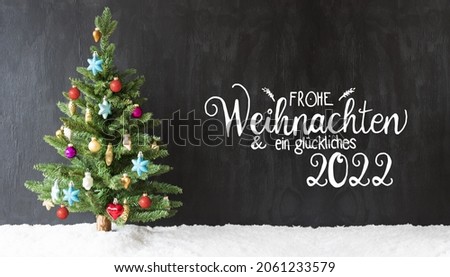 German Calligraphy Frohe Weihnachten Und Ein Glueckliches 2022 Means Merry Christmas And A Happy 2022. Christmas Tree With Colorful Ball Ornament And Snow