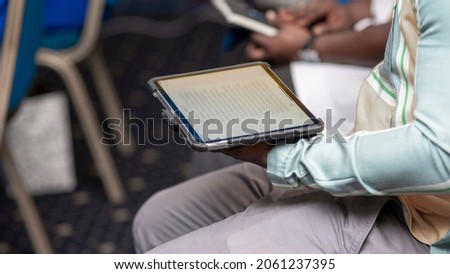 cropped image of a black person using mobile tablet indoor - concept on technology and communication