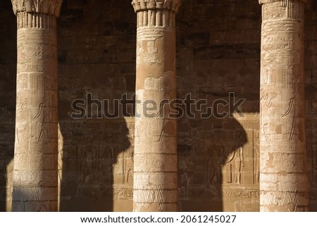 EXPLORING EGYPT - Massive columns inside beautiful Egyptian landmark with hieroglyphics, and ancient symbols. Famous landmark in the world near the Nile River and Luxor, Egypt Royalty-Free Stock Photo #2061245027