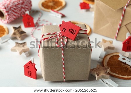 Secret Santa and Christmas composition on white wooden background.