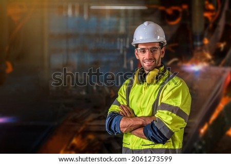 Portrait of Engineer with craftsman tool blurred backgrounf in the factory Royalty-Free Stock Photo #2061273599