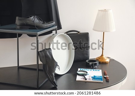 Stylish male accessories on table near light wall Royalty-Free Stock Photo #2061281486