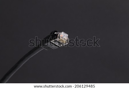 Image shows a black Network Cable on a dark background