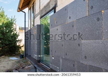 facade with thermal insulation of a single-family house Royalty-Free Stock Photo #2061359453