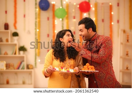 Young couple celebrating diwali with full of happiness Royalty-Free Stock Photo #2061362540