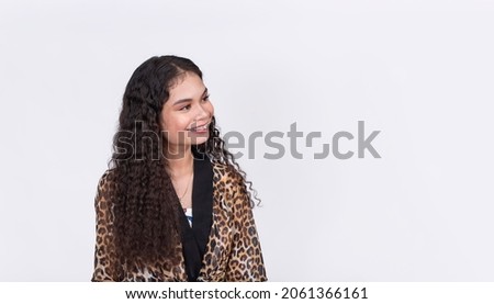 A pretty asian woman looking on her left, smiling and slightly tilting her head. Wearing a leopard print tie waist blazer. On a white background.