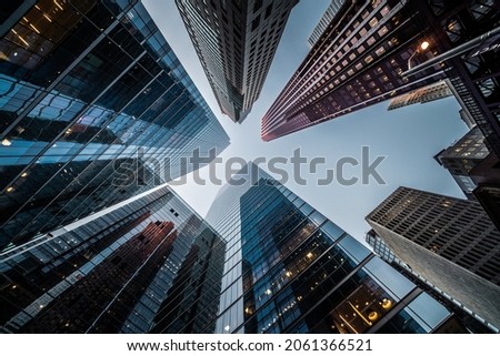 Business and finance concept, looking up at high rise office building architecture in the financial district of a modern metropolis. Royalty-Free Stock Photo #2061366521