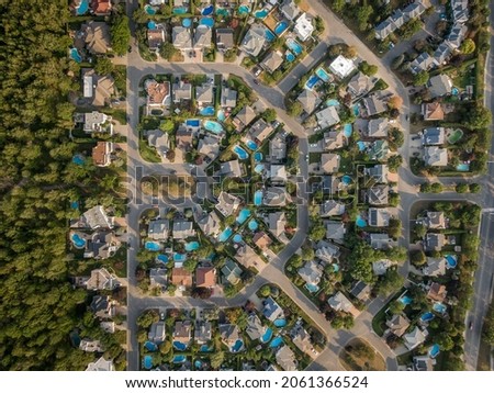 Top down aerial view of houses and streets in beautiful residential neighbourhood in Montreal, Quebec, Canada, North America. Property, homes and real estate concept, summer season. Royalty-Free Stock Photo #2061366524