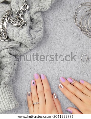 Womans hands with trendy lavender manicure. Fashion clothes and accessories