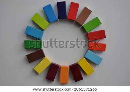 3D design in colourful toy wooden blocks reminiscent of the sustainable development goals logo. To convey ideas of sustainability, climate change, towards children. Not an official logo of the 17 SDG. Royalty-Free Stock Photo #2061391265