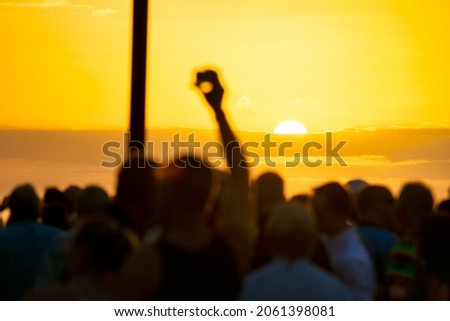 People take pictures of the famous sunset at Mallory Square, Key West