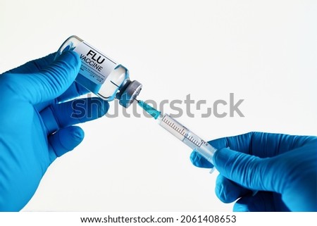 vaccination for booster shot for Flu virus in the risk population diseases. Doctor with syringe and vial of the dose vaccine for Flu or Influenza virus. Medicine and health care concept Royalty-Free Stock Photo #2061408653