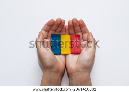 flag of Romania made of plasticine in the hands of a child on a white background Royalty-Free Stock Photo #2061410882