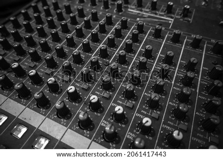 Black and white Professional sound and audio mixer control panel with buttons and sliders