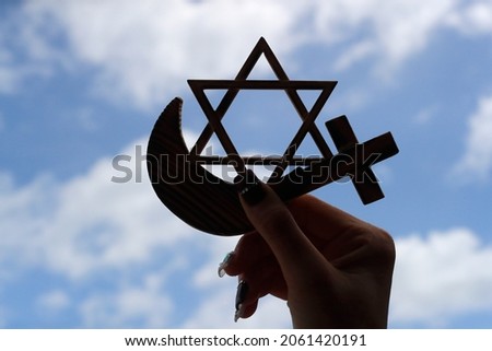 Christianity, Islam, Judaism  3  monotheistic religions. Jewish  Star, Cross and Crescent :  Interreligious symbols in hand. Royalty-Free Stock Photo #2061420191