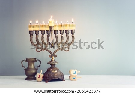 Religion image of jewish holiday Hanukkah background with menorah (traditional candelabra) and spinning top toy