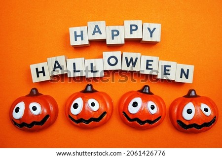 Happy Halloween alphabet letters top view on orange background