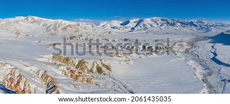 Panoramic aerial view of Kyzylchin river valley; Mars-1 and Terektinsky Mountain Range in winter. Altai Republic, Siberia, Russia.