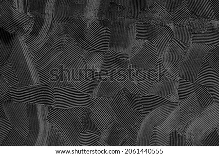 Embossed decorative plaster pattern with a pronounced black structure