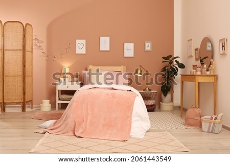 Teenage girl's bedroom interior with stylish furniture and beautiful decor elements