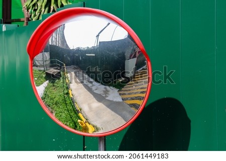 SINGAPORE - 4 OCT 2021: Convex mirrors are curved to provide drivers with wider views of the road than can be provided by flat mirrors, but they make objects appear to be smaller and farther away. Royalty-Free Stock Photo #2061449183