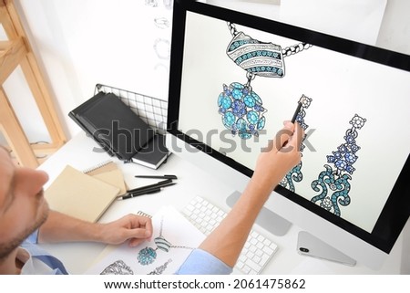 Male jewelry designer working in office Royalty-Free Stock Photo #2061475862