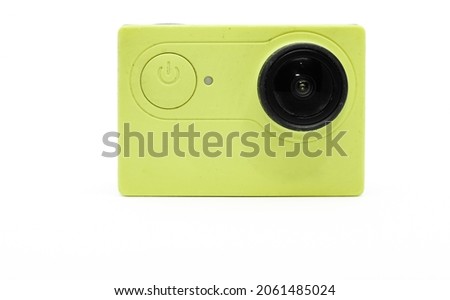 Light green compact high-resolution camera from the side of the power button and built-in lens on a white background.