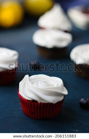 Lemon cupcakes with bilberry filled lemon curd and meringue frosting