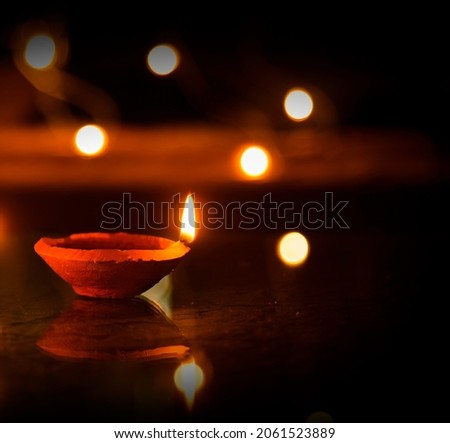 Happy Diwali - Diya lamps lit during diwali celebration Royalty-Free Stock Photo #2061523889