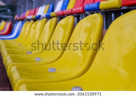 Plastic seats on sports arena after rain