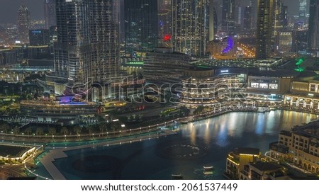 Dubai Fountain aerial night timelapse. Musical fountain, located in an artificial lake in downtown. Top view from above with evening illumination