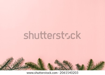 Minimal creative flat lay of christmas traditional composition and new year holiday season. Top view winter christmas decorations on pink background with blank space for text. Copy space photography.