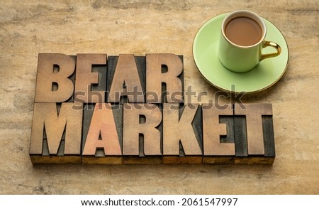bear market word abstract in letterpress wood type with a cup of coffee, pessimism,  finance, business and economy recession concept