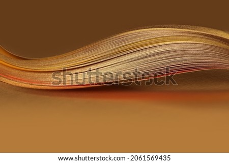 Abstract backgound. Gold (bronze) wave on brown. Royalty-Free Stock Photo #2061569435