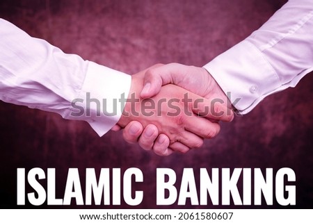 Conceptual caption Islamic Banking. Conceptual photo Banking system based on the principles of Islamic law Two Professional Well-Dressed Corporate Businessmen Handshake Indoors
